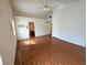 Large living room with high ceiling, hardwood floors, neutral paint, and a ceiling fan at 7209 London Bridge Ave, Las Vegas, NV 89130