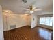 Inviting living room with durable laminate flooring, ceiling fan, and ample space for furnishings at 7209 London Bridge Ave, Las Vegas, NV 89130