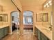 Spacious bathroom with double vanities, modern countertops, framed mirrors, and a connecting bedroom at 7400 W Flamingo Rd # 2058, Las Vegas, NV 89147