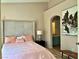Cozy bedroom featuring a luxurious upholstered bed frame, decorative pillows, and ensuite bathroom at 7400 W Flamingo Rd # 2058, Las Vegas, NV 89147