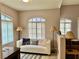 Bright living room with white sofa, decorative pillows, floor lamps, and natural light from arched windows at 7400 W Flamingo Rd # 2058, Las Vegas, NV 89147