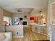 Open-concept living area featuring a fireplace, breakfast bar, and seamless flow into the adjacent spaces at 7400 W Flamingo Rd # 2058, Las Vegas, NV 89147