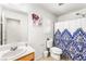 Bright bathroom featuring white tile, vanity, and shower with modern fixtures at 7832 Hamilton Pool Dr, Las Vegas, NV 89113