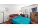 Bedroom featuring laminate flooring, natural light, and large television at 7832 Hamilton Pool Dr, Las Vegas, NV 89113