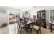 Elegant dining room with a classic chandelier, a dark wood table, and patio access at 7832 Hamilton Pool Dr, Las Vegas, NV 89113