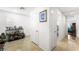 Bright hallway with neutral walls, closet, tile floors, and doorway leading to an airy bedroom at 7832 Hamilton Pool Dr, Las Vegas, NV 89113