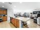 Open-concept kitchen with a large island, stainless steel appliances, and tile flooring at 7832 Hamilton Pool Dr, Las Vegas, NV 89113