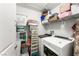 Clean laundry room with modern washer and dryer and shelving for storage at 7832 Hamilton Pool Dr, Las Vegas, NV 89113