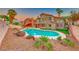 Spacious backyard featuring a large swimming pool, lush landscaping, and outdoor seating area at 8240 Campana Dr, Las Vegas, NV 89147