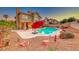 Backyard featuring a large swimming pool, lush landscaping, and outdoor seating area at 8240 Campana Dr, Las Vegas, NV 89147
