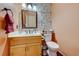 Charming powder room with whimsical wallpaper, wood cabinet vanity, and traditional fixtures at 8240 Campana Dr, Las Vegas, NV 89147