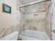 Modern bathroom features a shower over tub combination with custom stone tiling at 8240 Campana Dr, Las Vegas, NV 89147
