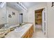 Bright bathroom with double sinks, tiled countertop, and separate toilet and shower area at 8240 Campana Dr, Las Vegas, NV 89147