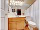 Bright bathroom with a wood vanity, large mirror, and shower/tub combo with a curtain at 8240 Campana Dr, Las Vegas, NV 89147