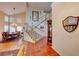 Inviting foyer with staircase, tile flooring, and a view into the dining room at 8240 Campana Dr, Las Vegas, NV 89147
