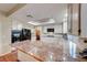 Bright kitchen with granite countertops, stainless steel appliances, tile backsplash and view into dining area at 8240 Campana Dr, Las Vegas, NV 89147