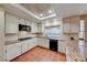 Well-equipped kitchen featuring granite countertops, stainless steel appliances, tile backsplash, and backyard views at 8240 Campana Dr, Las Vegas, NV 89147