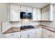 Modern kitchen with granite countertops, stainless steel appliances, gas range, and tile backsplash at 8240 Campana Dr, Las Vegas, NV 89147