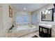 Elegant bathroom showcasing a soaking tub, single vanity, and natural light at 8240 Campana Dr, Las Vegas, NV 89147