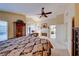 Open main bedroom featuring a fireplace, built-in cabinet, and a vaulted ceiling at 8240 Campana Dr, Las Vegas, NV 89147