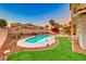Backyard with a beautiful pool, patio area, palm trees and manicured green lawn at 8240 Campana Dr, Las Vegas, NV 89147