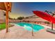 Swimming pool with a safety ladder surrounded by patio and desert landscaping at 8240 Campana Dr, Las Vegas, NV 89147