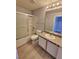 Bathroom with white vanity, granite counters, and tub with shower at 8600 W Charleston Blvd # 2089, Las Vegas, NV 89117