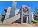 Two-story condo featuring stucco walls, red trim, and a private entrance at 8600 W Charleston Blvd # 2089, Las Vegas, NV 89117