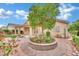 Spacious backyard featuring mature tree, brick-lined garden, and covered patio, perfect for relaxing at 8624 Burning Hide Ave, Las Vegas, NV 89143