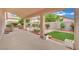 Covered backyard patio with brick accents and a view of the well-maintained garden at 8624 Burning Hide Ave, Las Vegas, NV 89143