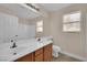 Bright bathroom with a double sink vanity, neutral paint, and a framed mirror at 8624 Burning Hide Ave, Las Vegas, NV 89143