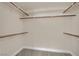 Walk-in closet with shelves and wooden hanging rods for organization at 8624 Burning Hide Ave, Las Vegas, NV 89143