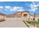 Inviting home featuring a three-car garage, well-maintained lawn, and desert-friendly plants at 8624 Burning Hide Ave, Las Vegas, NV 89143