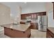 Beautiful kitchen with stainless steel appliances, tiled floors, and granite countertops at 8624 Burning Hide Ave, Las Vegas, NV 89143
