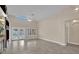 Open living room with tall ceilings, tiled floor, ceiling fan, and access to the backyard at 8624 Burning Hide Ave, Las Vegas, NV 89143