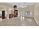 Spacious living room with built-in bar, a ceiling fan, and a door to the backyard at 8624 Burning Hide Ave, Las Vegas, NV 89143