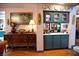 Charming bar area with custom cabinetry, countertops, sink, and decorative wall art at 9113 Anchor Cove Ct, Las Vegas, NV 89117