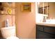 Compact bathroom with a toilet, a decorative shelf and mirror at 9113 Anchor Cove Ct, Las Vegas, NV 89117