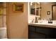 Compact bathroom with a toilet, a decorative shelf and mirror at 9113 Anchor Cove Ct, Las Vegas, NV 89117