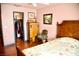Bedroom displaying a wooden bed frame, floral bedding, a sitting chair and a closet at 9113 Anchor Cove Ct, Las Vegas, NV 89117