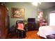 Relaxing bedroom showcases a comfortable recliner, classic furnishings and decor at 9113 Anchor Cove Ct, Las Vegas, NV 89117