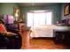 Cozy bedroom featuring hardwood floors, a bay window and classic furnishings at 9113 Anchor Cove Ct, Las Vegas, NV 89117