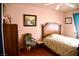 Bedroom showcasing a wooden bed frame, floral bedding, artwork, and a sitting chair at 9113 Anchor Cove Ct, Las Vegas, NV 89117
