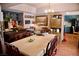 Elegant dining room featuring hardwood floors, chandelier lighting, and adjacent piano at 9113 Anchor Cove Ct, Las Vegas, NV 89117