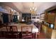 Spacious dining room with chandelier lighting, hardwood floors and adjacent bar area at 9113 Anchor Cove Ct, Las Vegas, NV 89117