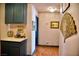 Hallway displaying green cabinets, decorations on the counter, and painting decorations along the walls at 9113 Anchor Cove Ct, Las Vegas, NV 89117