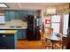 Open kitchen with hardwood floors, a breakfast area, and a stainless steel refrigerator at 9113 Anchor Cove Ct, Las Vegas, NV 89117