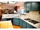 Bright kitchen featuring tile countertops, hardwood floors, and modern gas stovetop at 9113 Anchor Cove Ct, Las Vegas, NV 89117