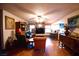 Spacious living room featuring hardwood floors, brick fireplace, and a large window for natural light at 9113 Anchor Cove Ct, Las Vegas, NV 89117
