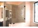 Modern bathroom featuring a tiled glass shower with decorative stained glass window at 9113 Anchor Cove Ct, Las Vegas, NV 89117
